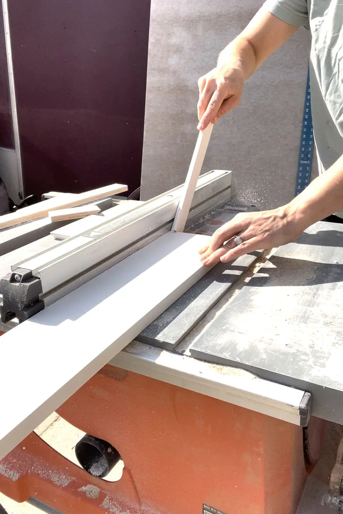 Using a table saw to cut PVC trim.